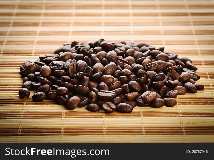 Handful aromatic coffee beans on a table