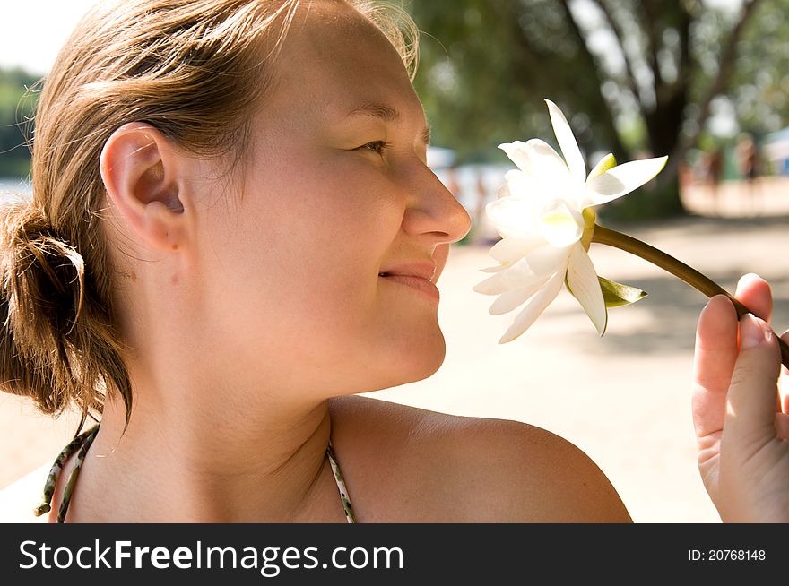 Portrait of cute woman with water-lily on a beach. Portrait of cute woman with water-lily on a beach
