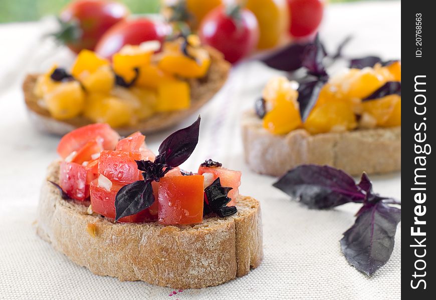 Bruschetta with tomato, onions and freshly chopped basil, selective focus