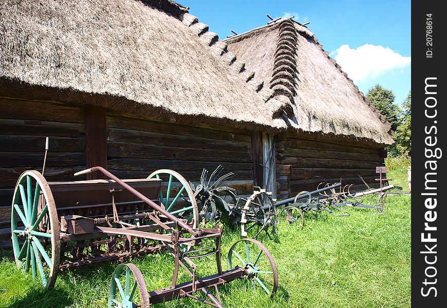 The old wooden barn and the display of agricultural equipment in the Open-Air Museum of the Lublin Region's Village, Lublin, Poland. The old wooden barn and the display of agricultural equipment in the Open-Air Museum of the Lublin Region's Village, Lublin, Poland