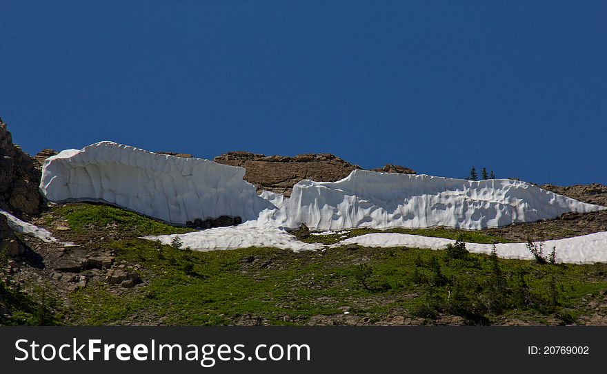 This image of the remaining cornice on the ridge top was taken in NW Montana in August. This image of the remaining cornice on the ridge top was taken in NW Montana in August.