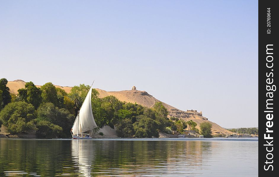 Traditional felluca boat sailing along the River Nile. Traditional felluca boat sailing along the River Nile