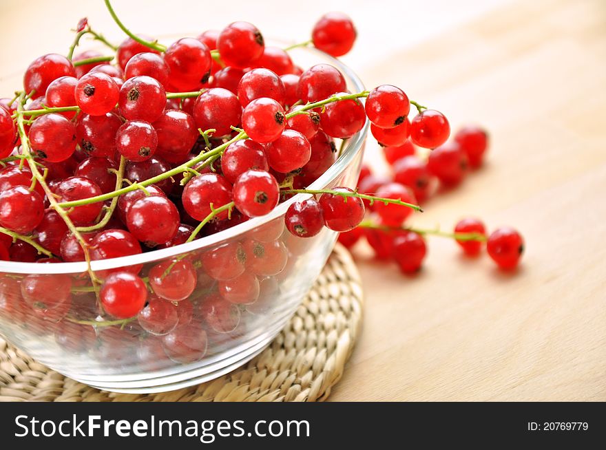 Fresh red currants in a glass bowl