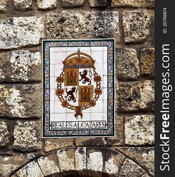 A wall with the coat of arms of Real Alcazar. A wall with the coat of arms of Real Alcazar