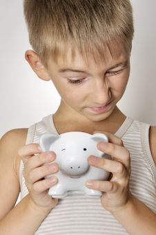 Boy With Piggy Bank Royalty Free Stock Images
