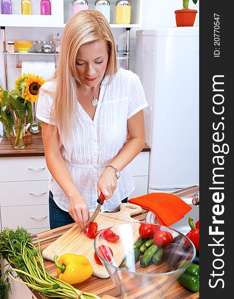 Lovely woman preparing food in the kitchen. Lovely woman preparing food in the kitchen