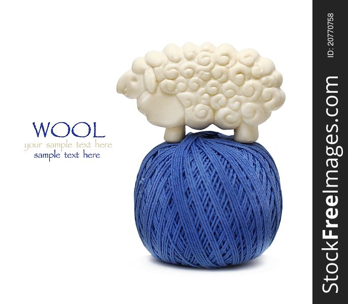 Blue ball of woollen thread on white with lamb figure soap on it