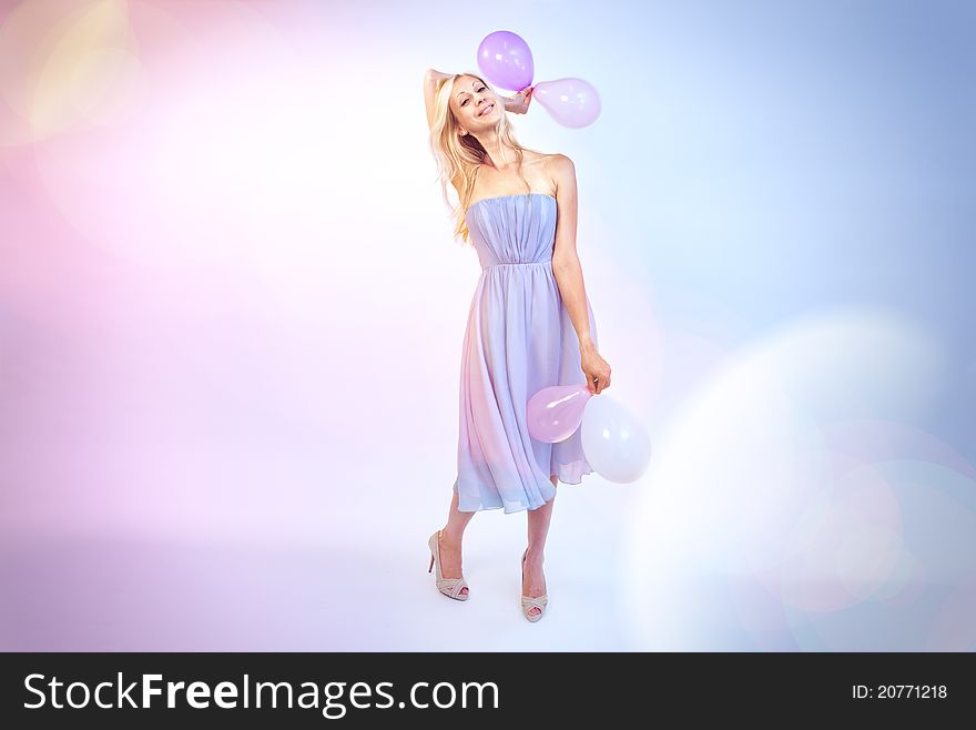 Woman wishes happy birthday, holding balloons in her hands. Woman wishes happy birthday, holding balloons in her hands