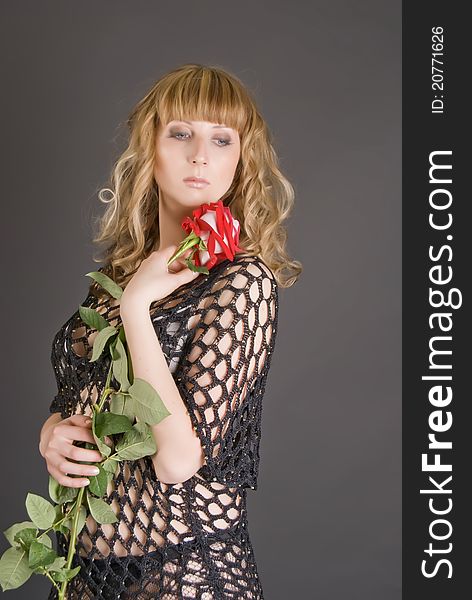 Beautiful girl with a red flower in hands. Beautiful girl with a red flower in hands