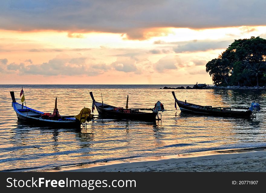 Three longtail boats near the beach in sunset. Three longtail boats near the beach in sunset