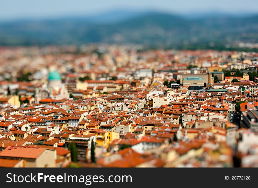 View on toy city with houses of orange roofs.