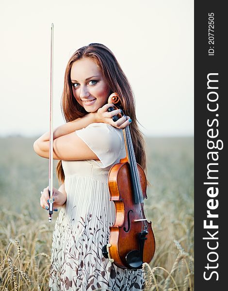 Young girl with violin over nature