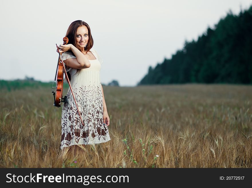 Young girl with violin over nature