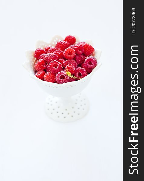 Bowl of raspberry on the white background. Bowl of raspberry on the white background