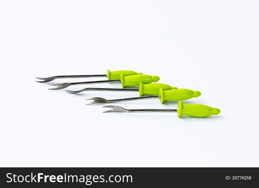 Carving forks on a white background made of ceramic and silver.