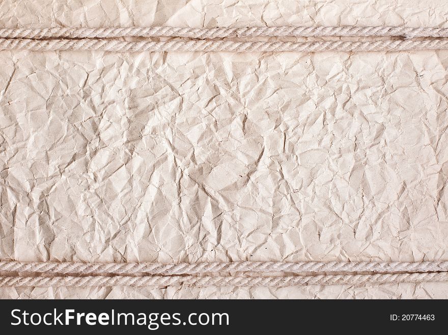 Crushed paper background with rope