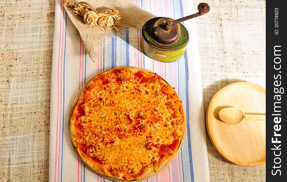 Italian pizza on table with pepper mill