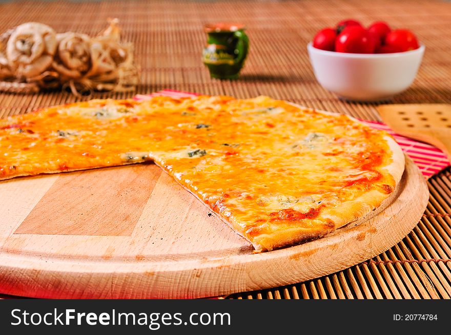 Italian pizza slice on table with small tomatoes