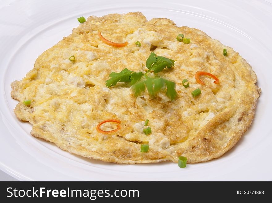 Yellow omelet chicken garnished with coriander