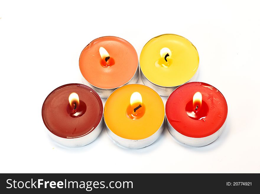 Red, orange and yellow candles on white background. Red, orange and yellow candles on white background