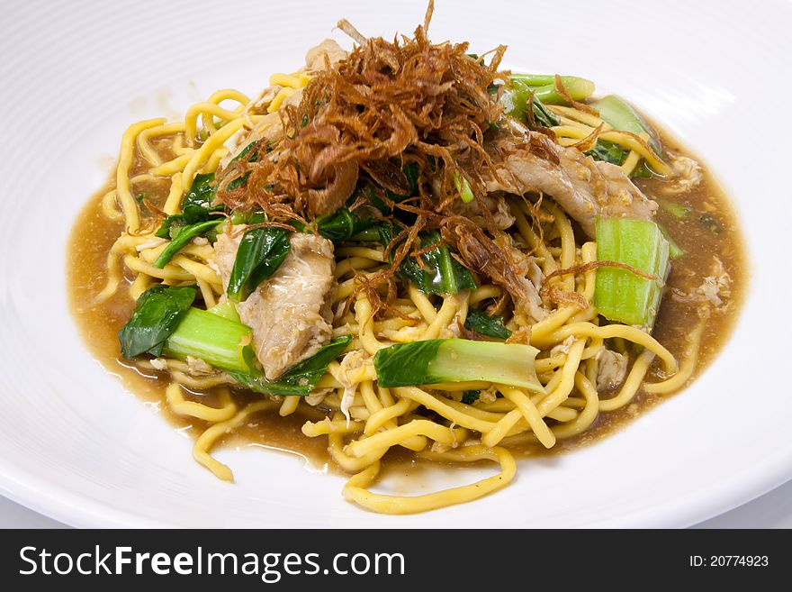 Wok fried Phuket egg noodles with pork and bok choy