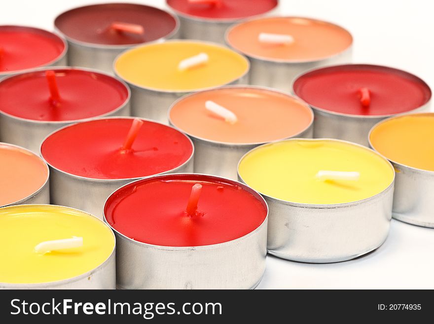 Red, orange and yellow candles on white background. Red, orange and yellow candles on white background
