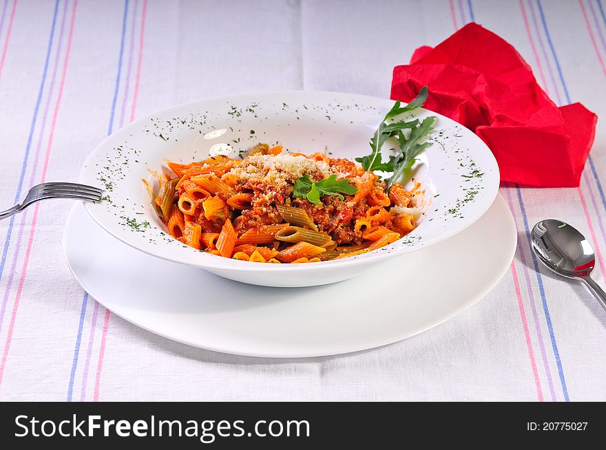 italian spaghetti pasta on table with spoon and fork