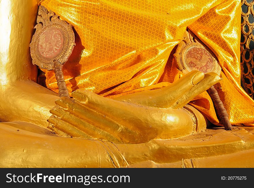 Hand of golden buddha statue at thai temple