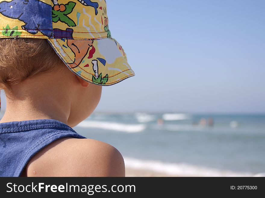 This photograph depicts a small child on the beach. This photograph depicts a small child on the beach.