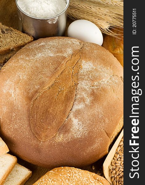 Bakery products and grain on wooden texture