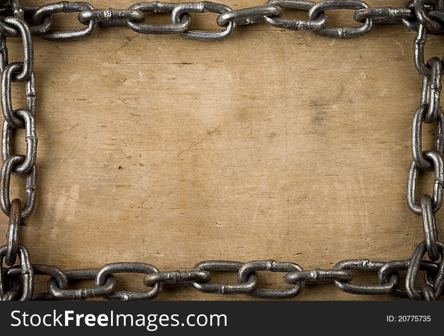 Metal chain on old wood background texture. Metal chain on old wood background texture