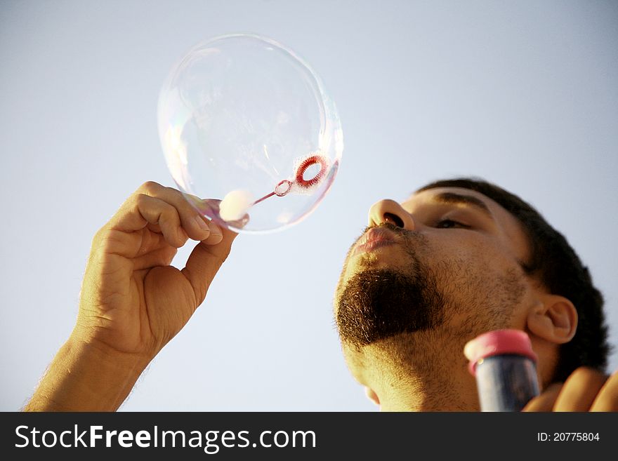 Man making bubbles in the sun