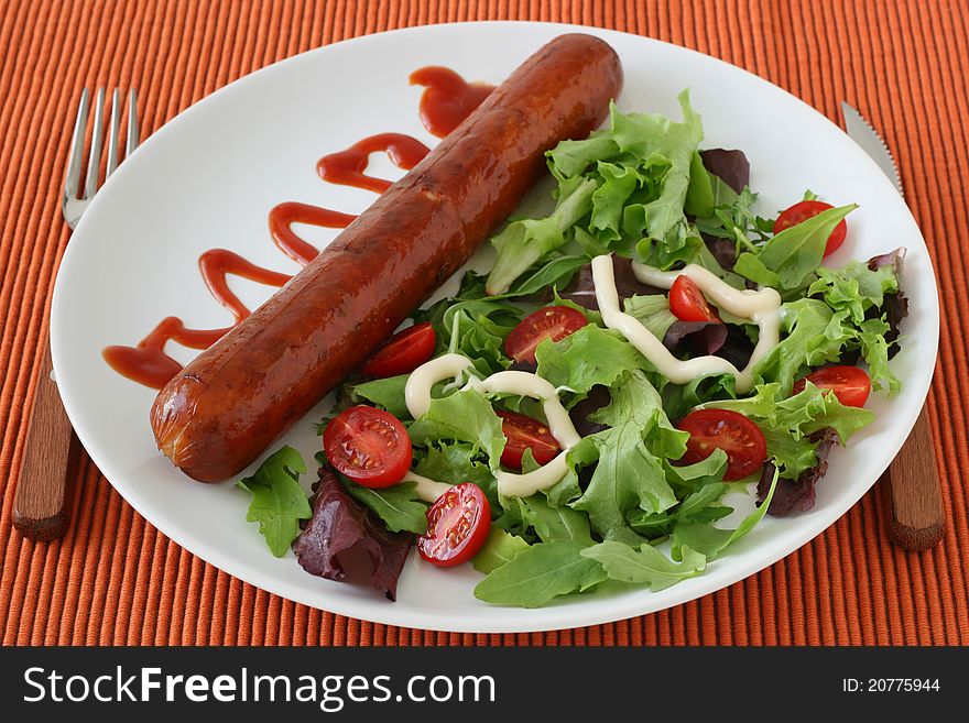 Fried sausage with salad and sauce