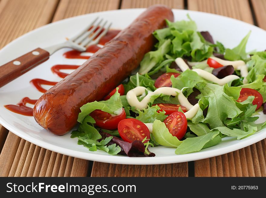 Fried sausage with salad and sauce