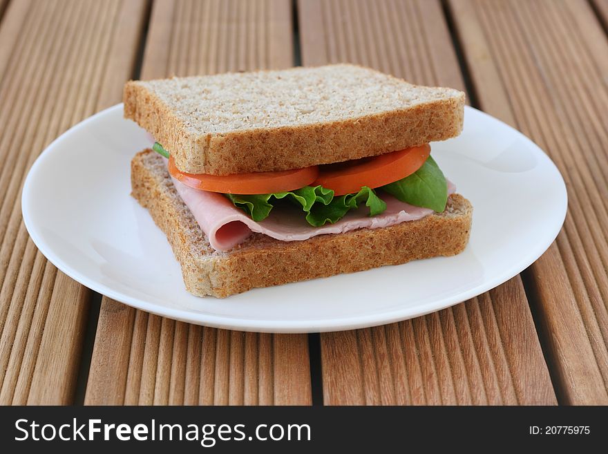 Toast with ham and tomato on a plate