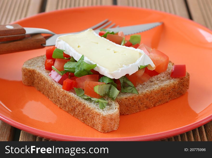 Toast with cheese camembert and cut tomato