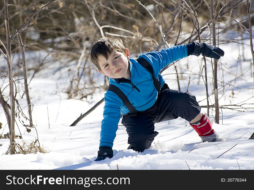 A lovely child playing with the white snow. A lovely child playing with the white snow