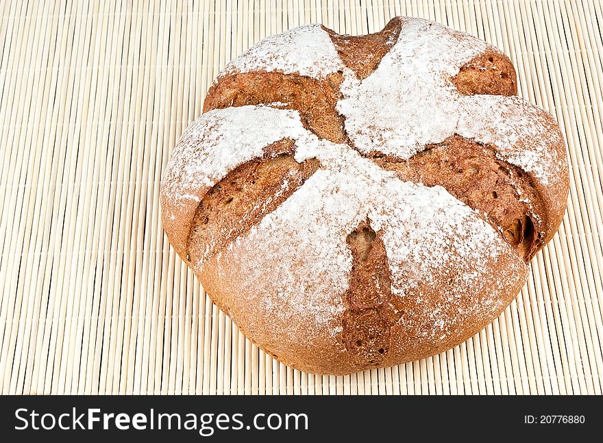 Loaf of rye bread on textured background