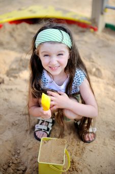 Happy Child Girl Is Playing In A Sandbox Stock Photography