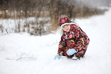 Child Girl In Colorful Snowsiut Plays In Snow Royalty Free Stock Photos Child Girl In Colorful Snowsiut Plays In Snow Royalty Free Stock Photos