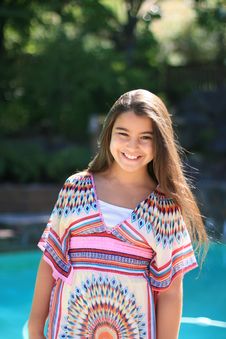 Cute Smiling Girl Outdoors By The Pool Royalty Free Stock Image