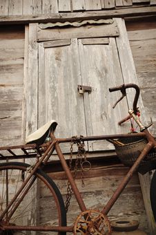 Old Bicycle And Old Wood House Royalty Free Stock Photos
