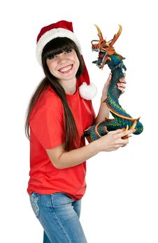 Girl In Santa Hat With A Decorative Wooden Dragon Stock Photo Girl In Santa Hat With A Decorative Wooden Dragon Stock Photo
