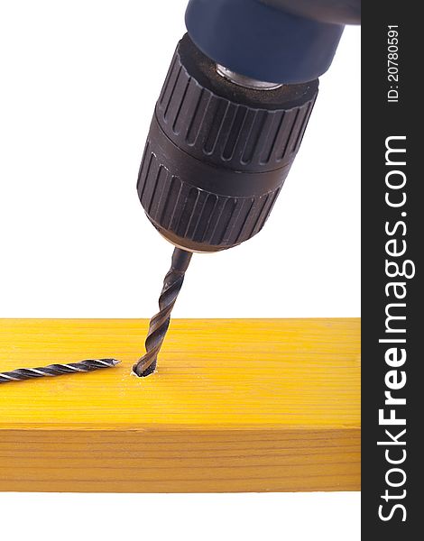 Studio-shot of drilling a hole into wood with a drilling machine, isolated on white.