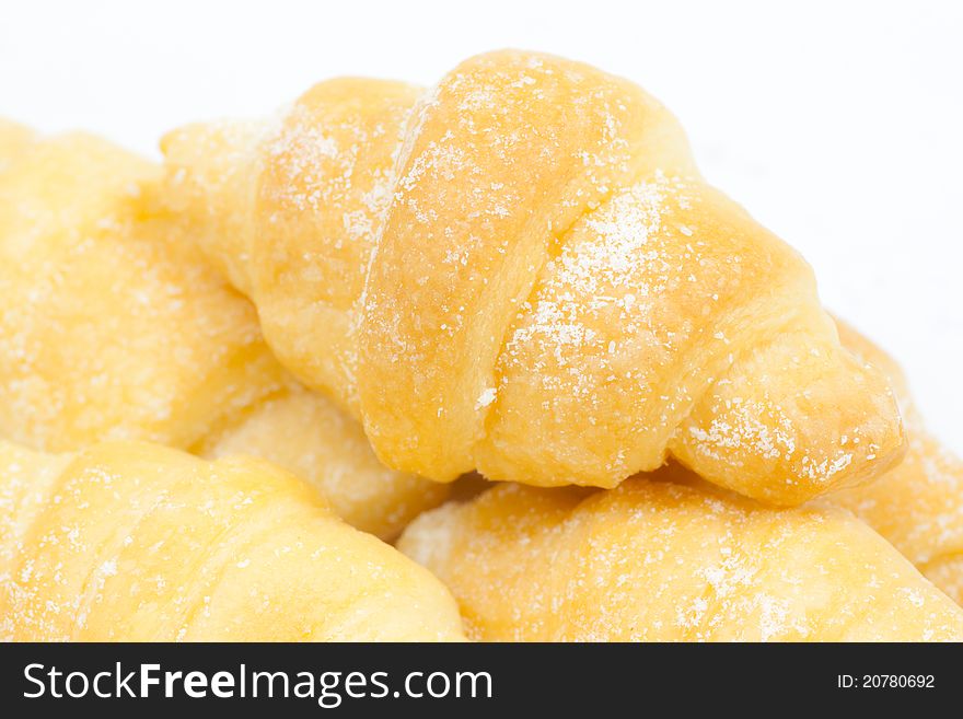 A group of croissants with icing on white background