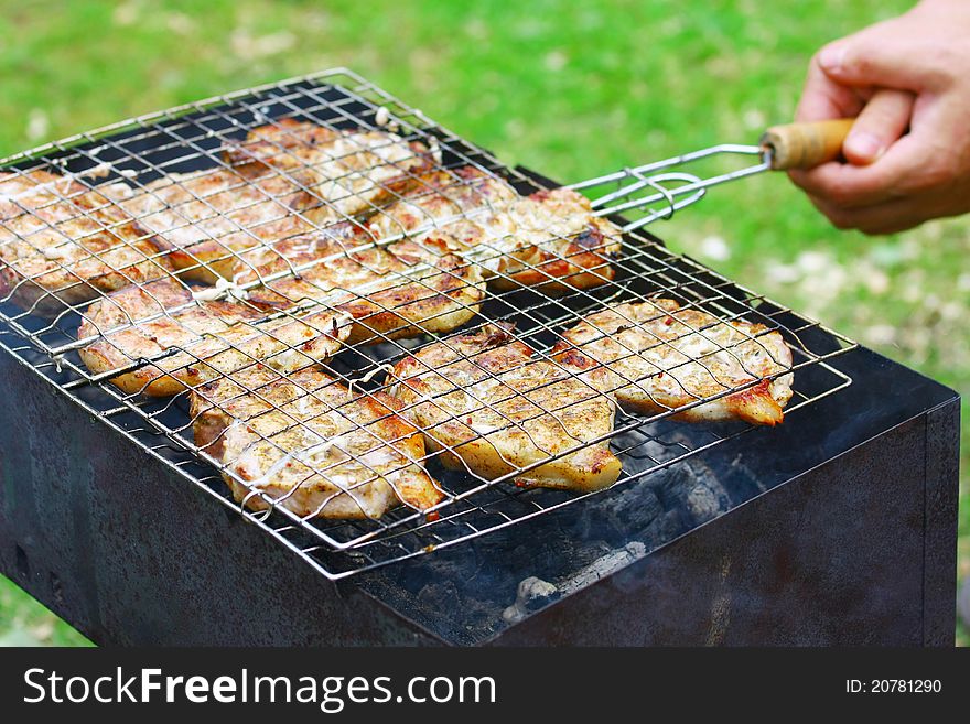 Steaks in Barbecue grill in cook's hands