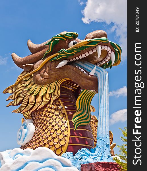 Head of golden dragon statue with blue sky