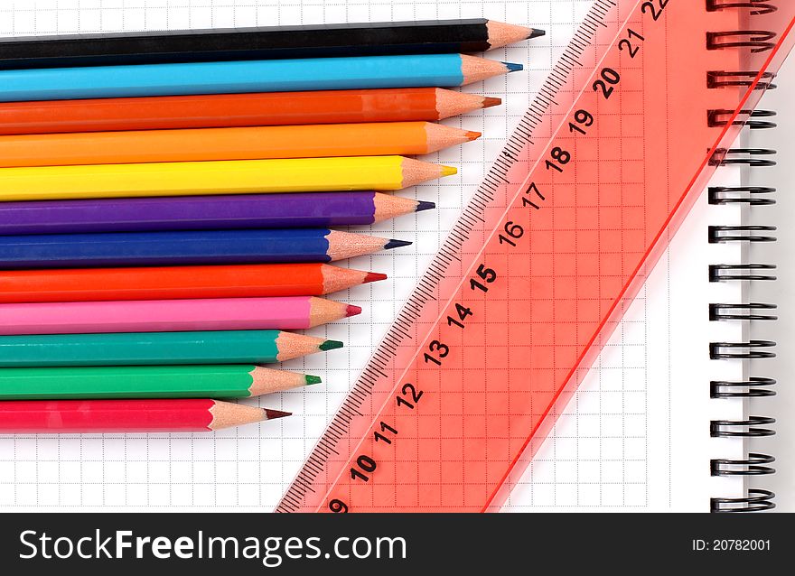 Color photo of a set of pencils on notepad. Color photo of a set of pencils on notepad