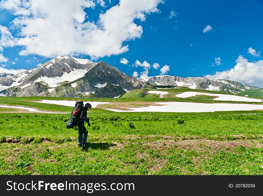 Tourist with a backpack on the background of snowy mountains. mountains of North Caucasus