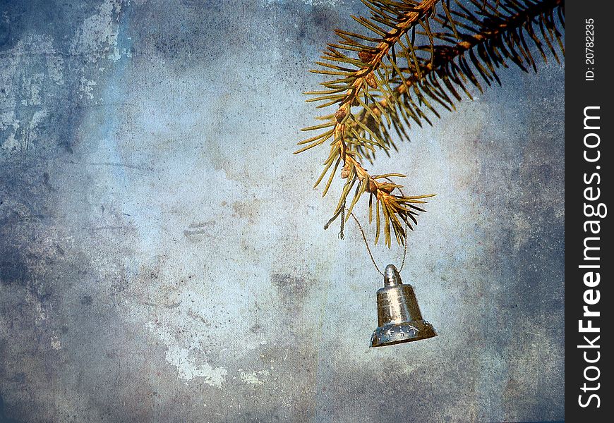 Vintage style antique textured image of a little silver bell hanging from a pine branch with copy space. Vintage style antique textured image of a little silver bell hanging from a pine branch with copy space.